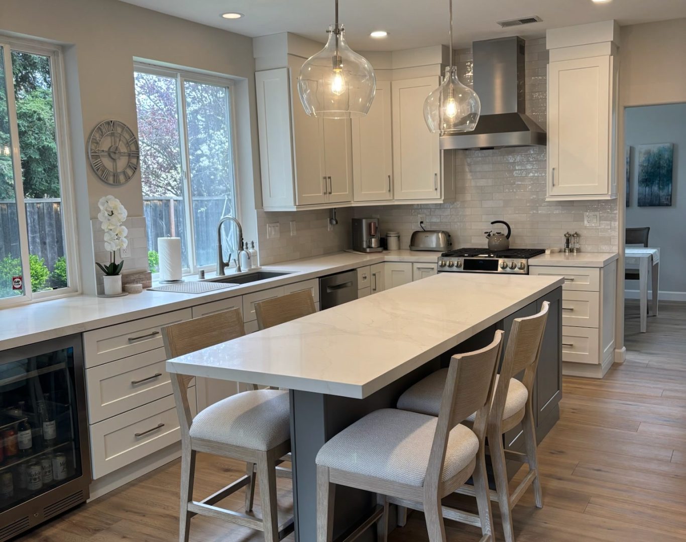 Kitchen Remodeling San Francisco Bay Area, Luxury kitchen renovation with custom island, premium cabinetry, and designer pendant lighting, Family enjoying newly remodeled kitchen with custom island and bright storage solutions, Homeowner enjoying updated kitchen with new cabinets, bright lighting, and expanded counter space, Family reviewing kitchen island layout during active remodel in a Dublin home, Homeowner reviewing custom cabinet samples and stone slabs for upscale kitchen renovation