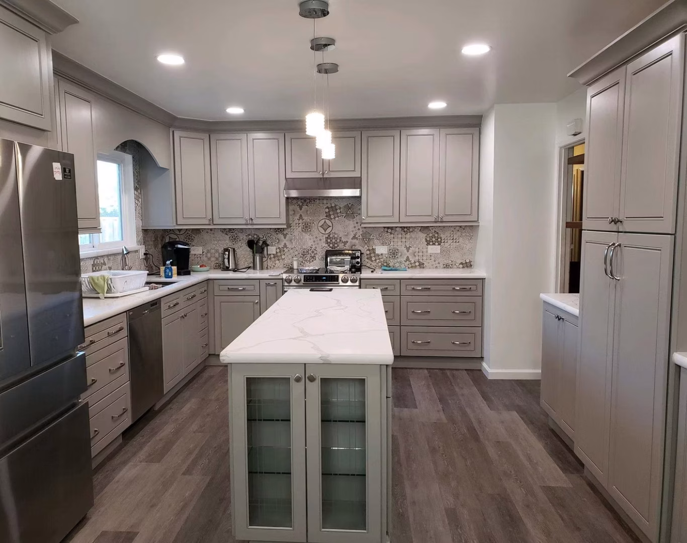 Family enjoying newly remodeled kitchen with custom island and updated lighting, Contractor reviewing kitchen measurements and cabinet plans before renovation work begins, Remodeling specialist evaluating outdated kitchen layout and planning efficient cabinet placement