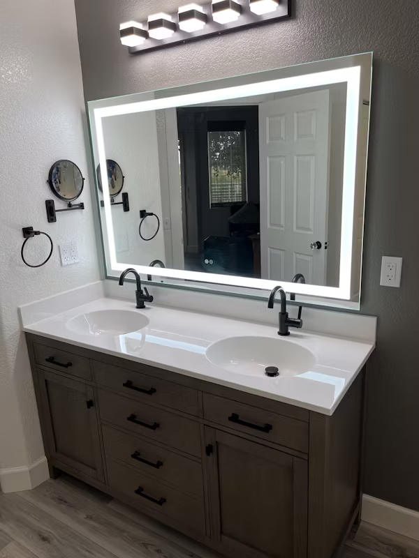 Skilled remodeler reviewing premium tile layout and fixture spacing in upscale bathroom, Contractor installing large-format tile and floating vanity in updated Walnut Creek bathroom