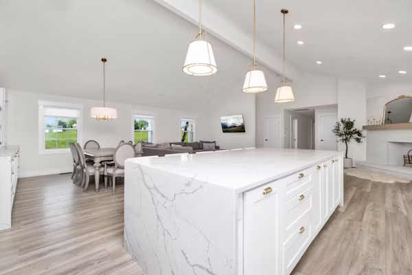 Experienced kitchen remodeler inspecting cabinetry, ventilation, and finish details on site