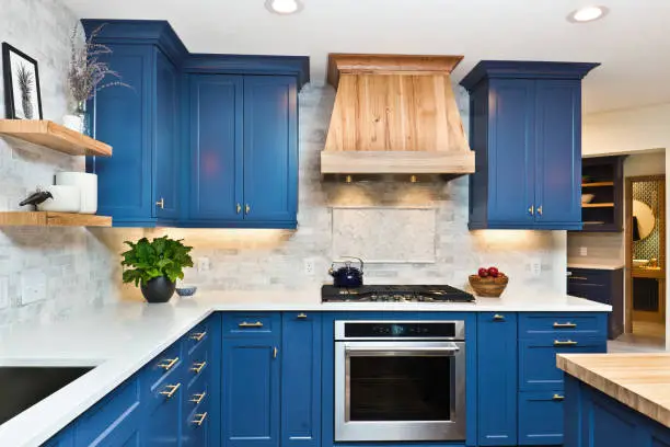Experienced kitchen remodeler inspecting outdated cabinets and inefficient workspace layout, Remodeling specialist inspecting kitchen layout, measurements, and cabinet installation details