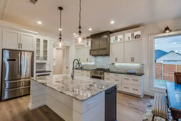 Family kitchen renovation with new cabinets, counters, and improved lighting layout