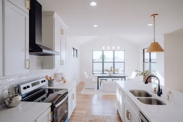 Skilled remodeler evaluating kitchen layout, ventilation, and cabinet installation details