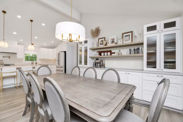 Skilled remodeler evaluating kitchen layout and cabinet placement options