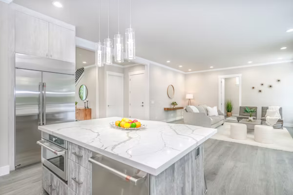 Homeowner reviewing new kitchen layout during active cabinet and countertop renovation